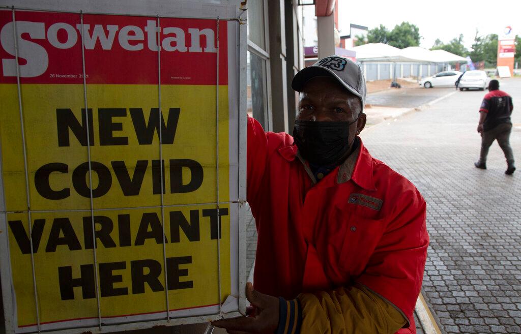 A petrol attendant stands next to a newspaper headline in Pretoria, South Africa, Nov 27. As the world grapples with the emergence of the new variant of Covid-19, scientists in South Africa – where Omicron was first identified – are scrambling to combat its spread across the country. Photo: AP