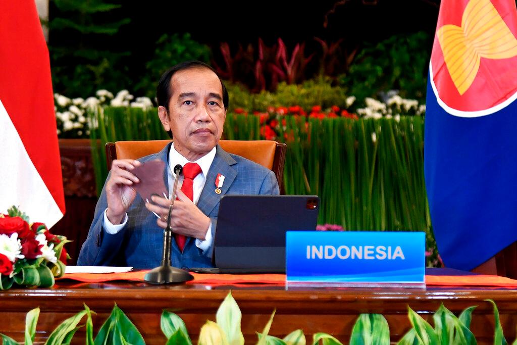 In this photo released by Indonesian Presidential Palace, Indonesian President Joko Widodo removes his mask during the virtual Asean-China leaders' summit at the State Palace in Jakarta, Indonesia, Nov 22. China is Indonesia's biggest trade partner and second-largest source of investment, making it a key part of Indonesia's ambition to become a top-tier economy. Photo: AP