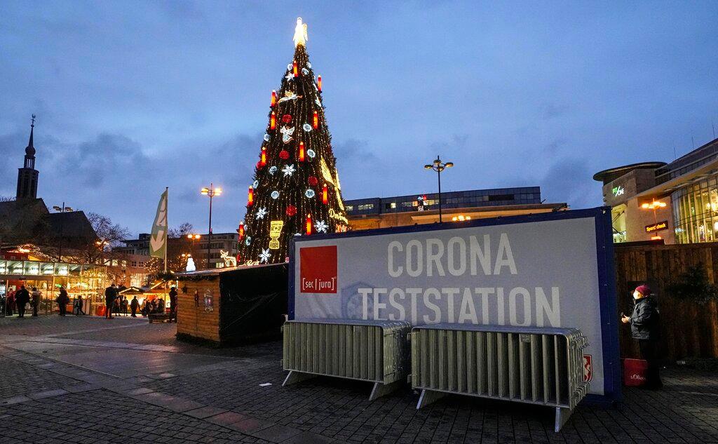 A woman asks for a Covid-19 test, beside Germany's biggest Christmas tree at the Christmas market in Dortmund, Germany, Dec 1. Photo: AP