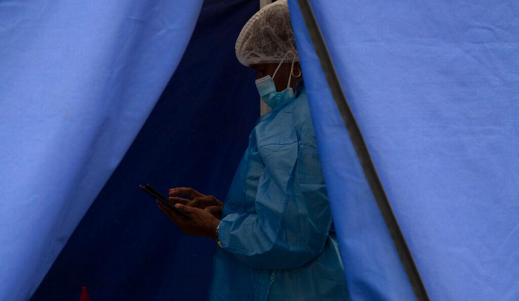 A healthcare worker waits to test people for Covid-19 at a facility in Soweto, South Africa, Dec 2. Photo: AP
