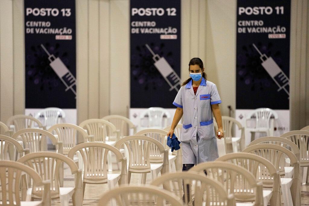 A worker disinfects chairs at a new vaccination centre in Lisbon, Portugal, Nov 30. Photo: AP