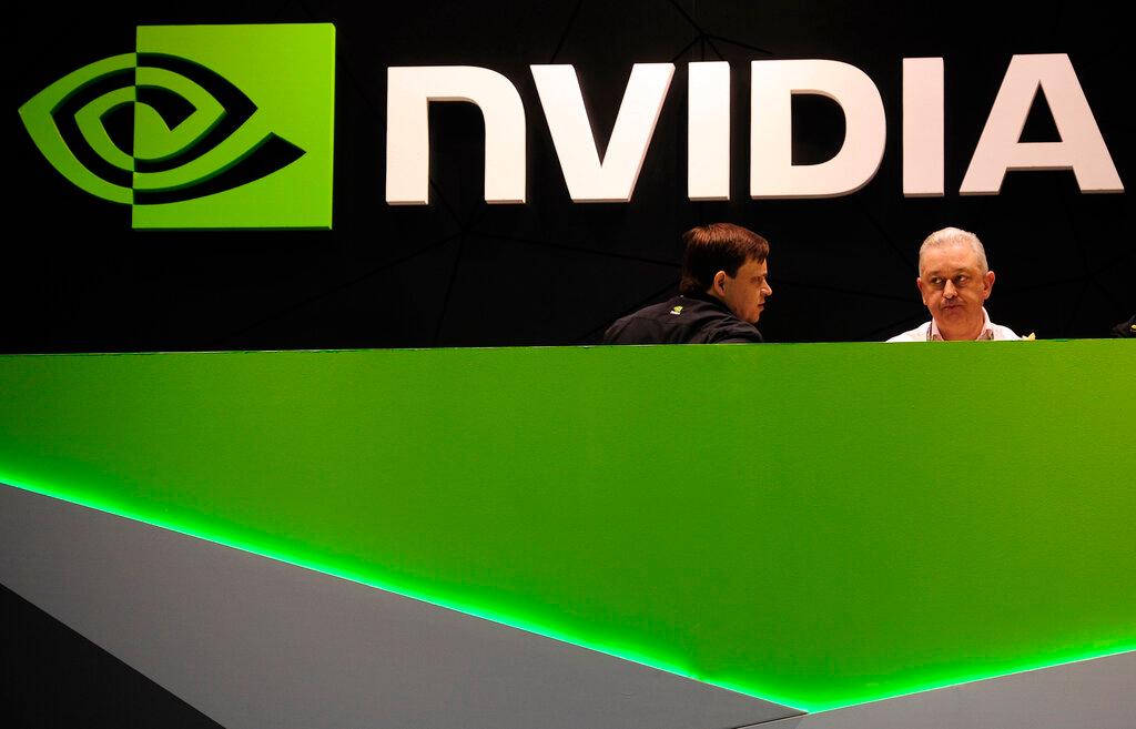 In this file photo dated Feb 27, 2014, people gather in the Nvidia booth at the Mobile World Congress mobile phone trade show in Barcelona, Spain. UK regulators said Jan 6 they are investigating graphics computer chip maker Nvidia's US$40 billion purchase of chip designer Arm Holdings over concerns about its effect on competition. Photo: AP