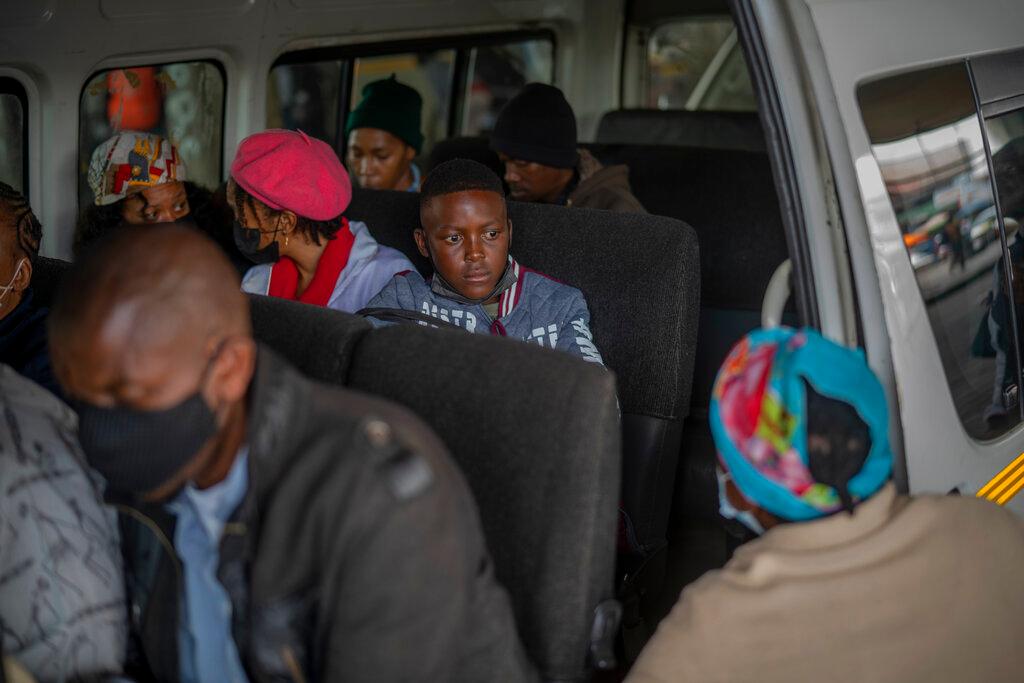Passengers, some wearing masks, wait for their taxi to leave the Baragwanath taxi rank in Soweto, South Africa, Dec 2. Photo: AP