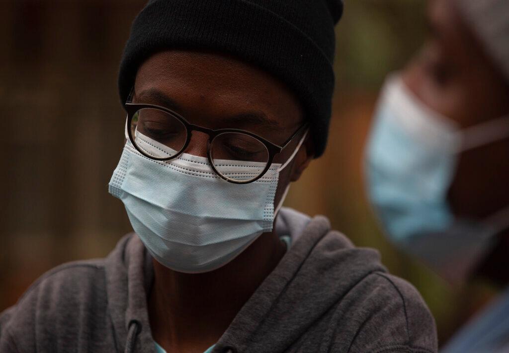 A student from the Tshwane University of Technology wears a face mask outside his residence in Pretoria, South Africa, Nov 27. Photo: AP