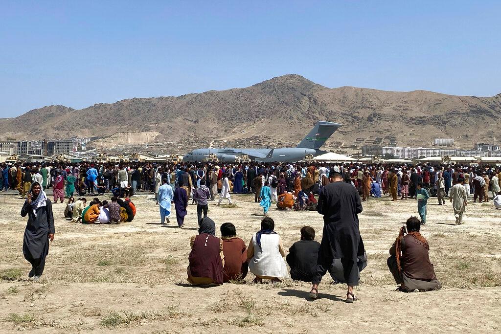 Hundreds of people gather near a US Air Force C-17 transport plane at a perimeter at the international airport in Kabul, Afghanistan, on Aug 16. Photo: AP