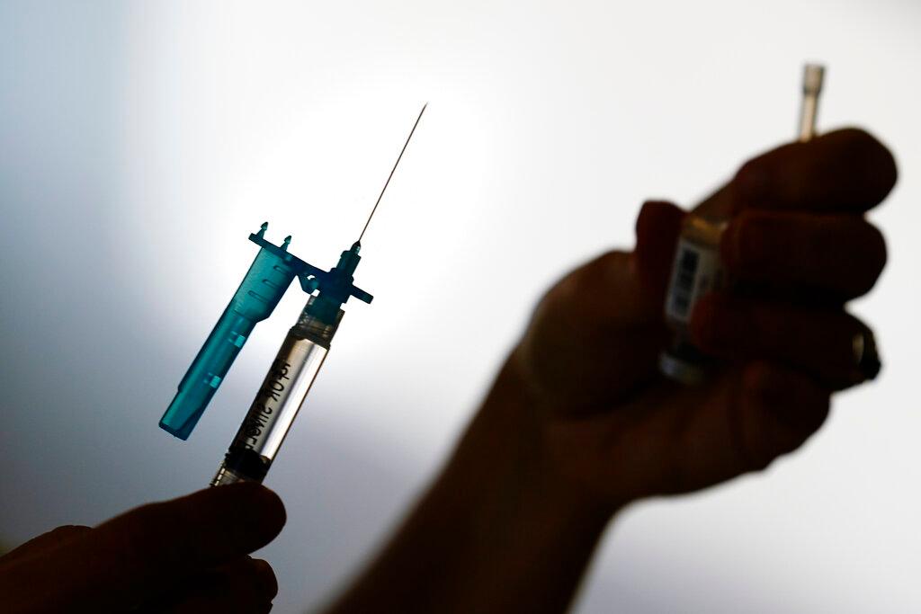 A health worker prepares a syringe of the Pfizer Covid-19 vaccine at a clinic in Norristown, Pennsylvania, Dec 7. Photo: AP