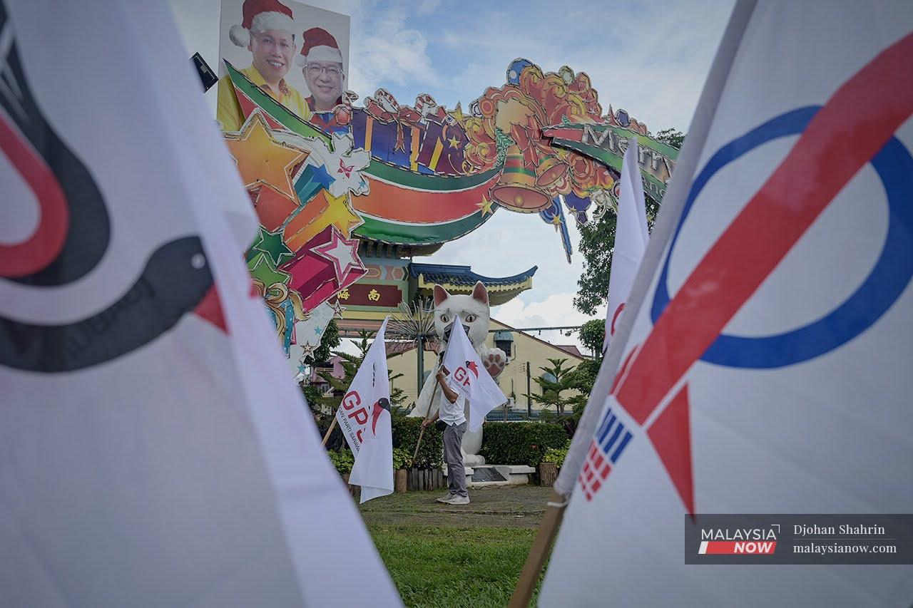 Gabungan Parti Sarawak flags are put up amid the flags of DAP at the Kuching city centre ahead of the state election on Dec 18.