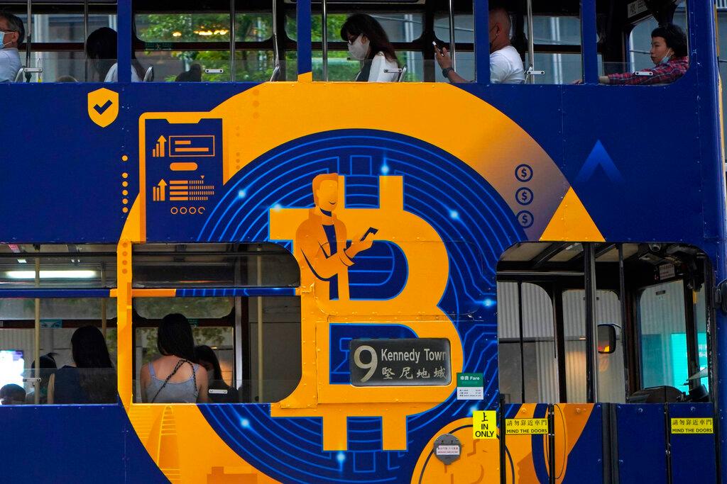 This May 12 file photo shows an advertisement for the cryptocurrency Bitcoin displayed on a tram in Hong Kong. Cryptocurrency has taken digital transaction by storm ever since the introduction of Bitcoin, the pioneer cryptocurrency launched in 2009. Photo: AP