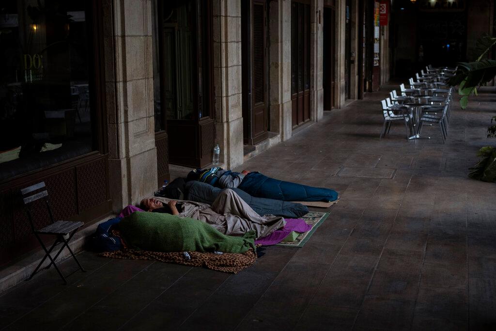 Homeless people sleep in a street in downtown Barcelona, Spain, in this June 4 file picture. Photo: AP