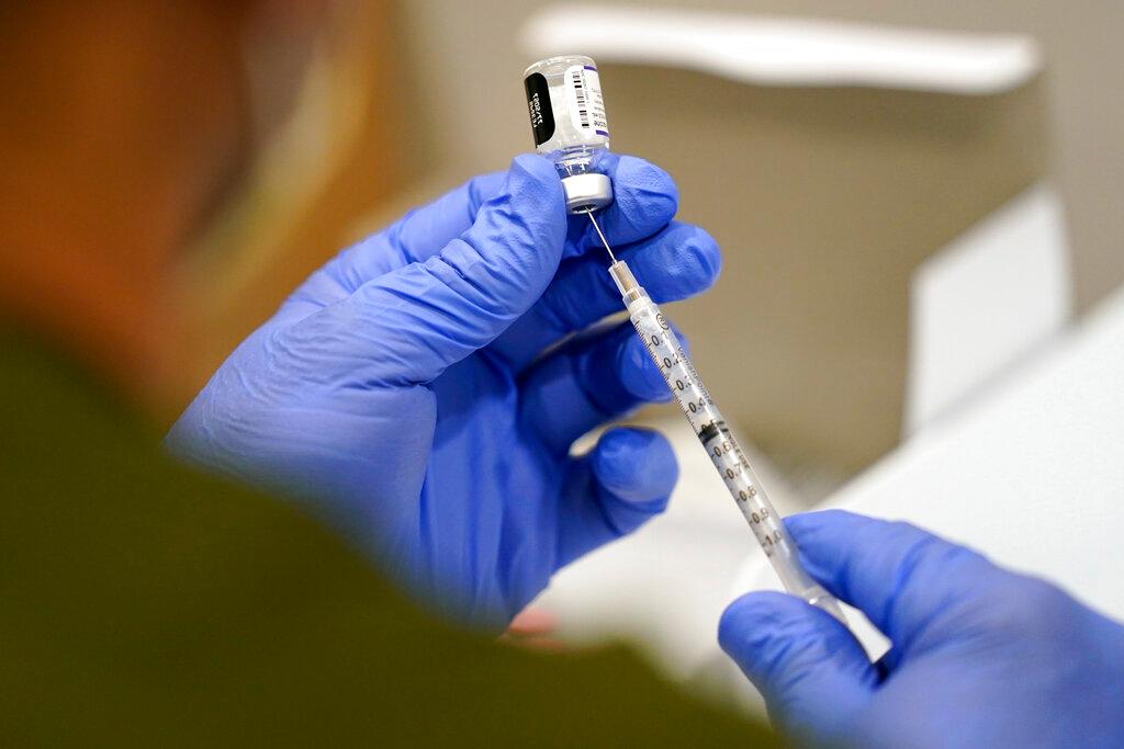A healthcare worker fills a syringe with the Pfizer Covid-19 vaccine at Jackson Memorial Hospital, Oct 5, in Miami. Nearly 8,500 active duty members of the Air Force and Space Force have missed the deadline for getting Covid-19 vaccinations, including 800 who flatly refused and nearly 5,000 with pending requests for a religious exemption, the Air Force said, Nov 3. Photo: AP