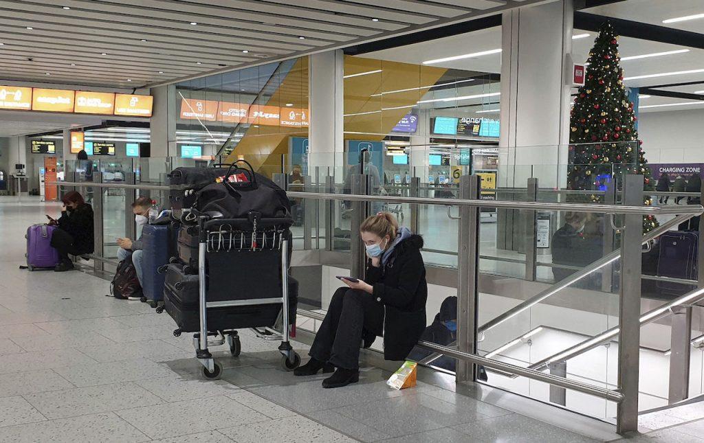 Passengers wait at Gatwick Airport in West Sussex, England, Dec 20, 2020. Photo: AP