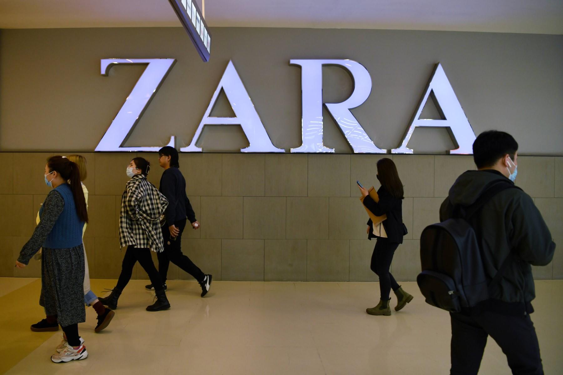 In this file photo taken on March 31, people walk past a Zara clothing store in Beijing. Photo: AFP