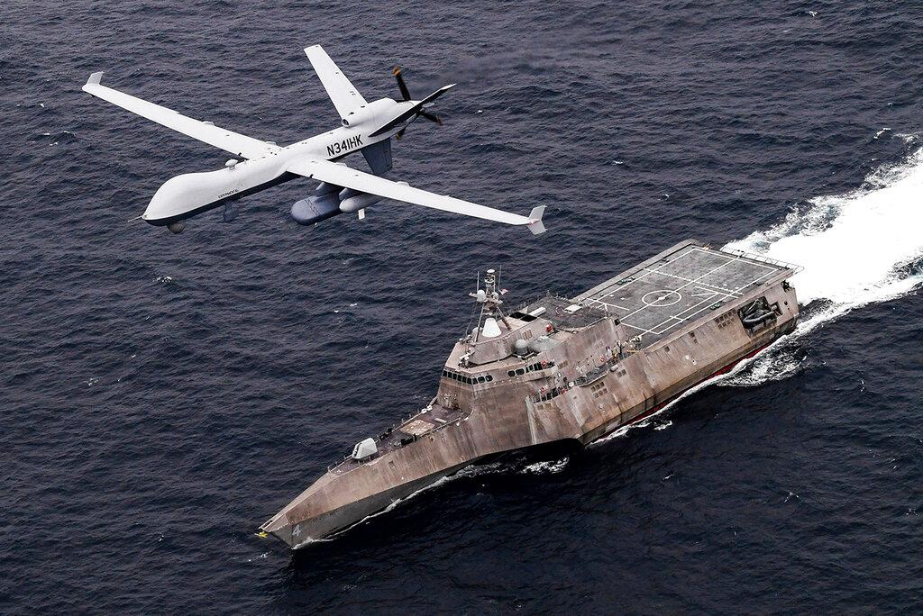 In this handout image from the US Navy, an MQ-9 Sea Guardian unmanned maritime surveillance drone flies over the USS Coronado in the Pacific Ocean during a drill April 21. Photo: AP