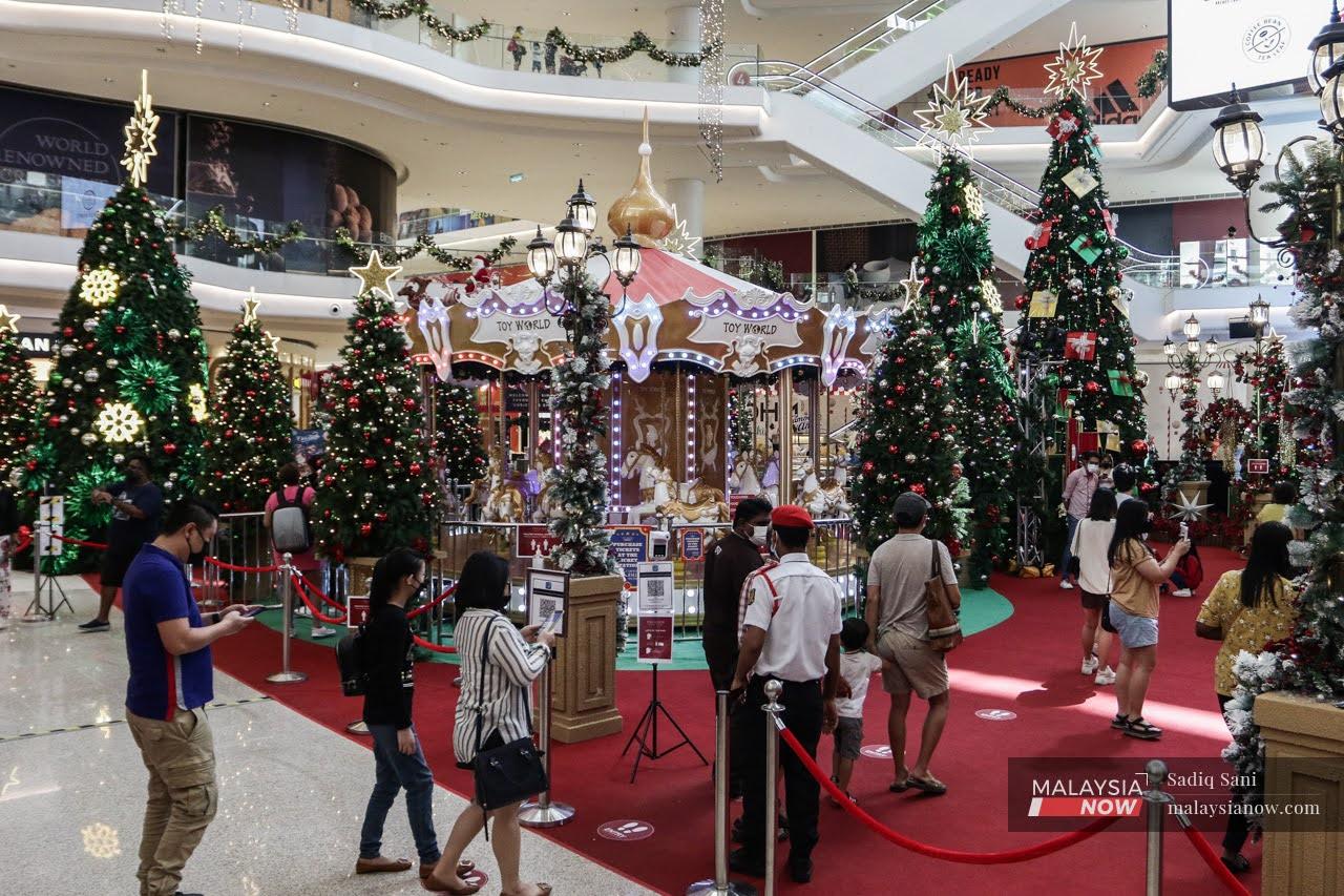 People queue to take pictures with the Christmas decorations at a mall in Kuala Lumpur.