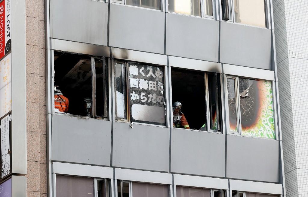 Firefighters work at the scene where 27 people were feared dead after a blaze at a building in Osaka, on Dec 17. Photo: AFP