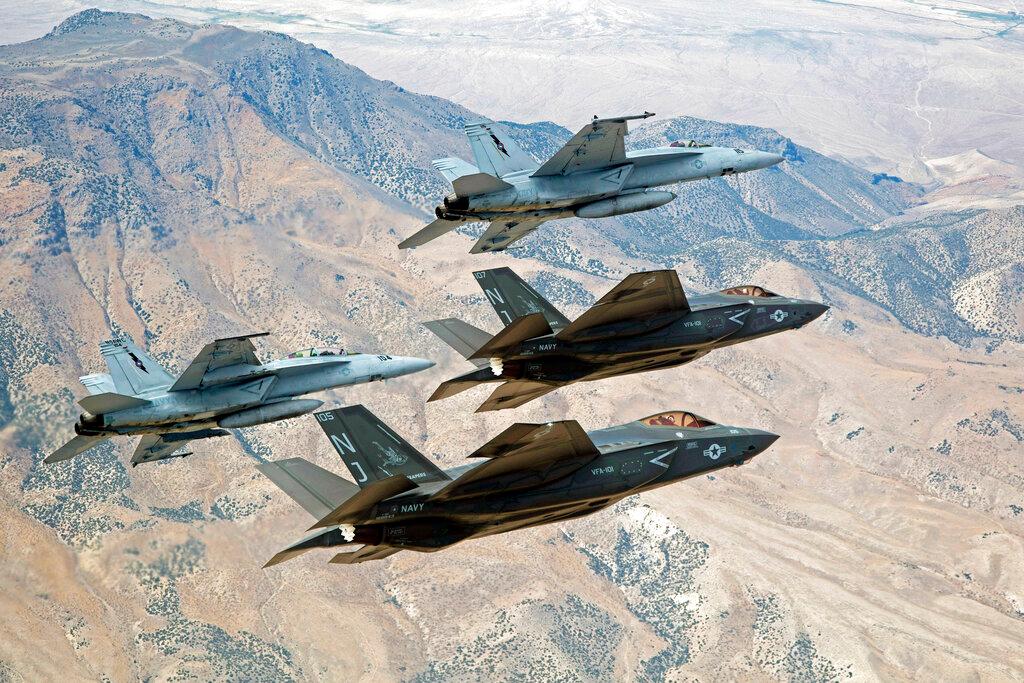 In this Sept 3, 2015, file photo provided by the US Navy, F-35C Lightning IIs, attached to the Grim Reapers of Strike Fighter Squadron 101, and F/A-18E/F Super Hornets attached to the Naval Aviation Warfighter Development Center, fly over Naval Air Station Fallon's Range Training Complex near Fallon, Nevada. Photo: AP