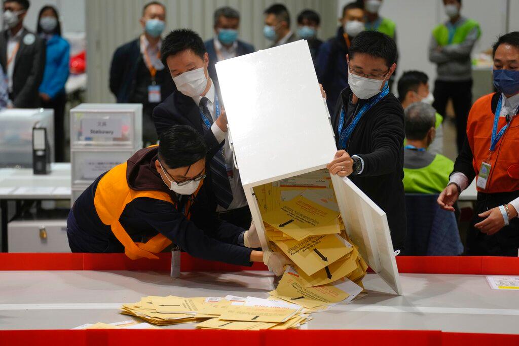 Election workers empty a ballot box to count votes at a polling station for the legislative election in Hong Kong, Dec 19. Photo: AP