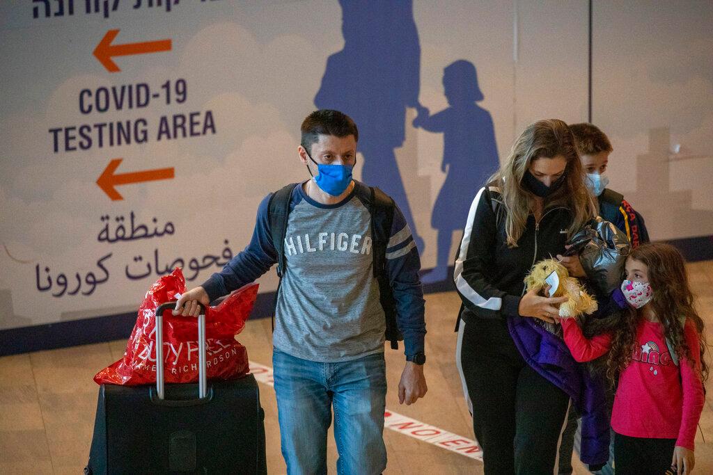 Travellers wearing protective face masks arrive at the Ben Gurion Airport near Tel Aviv, Israel, Nov 28. Photo: AP