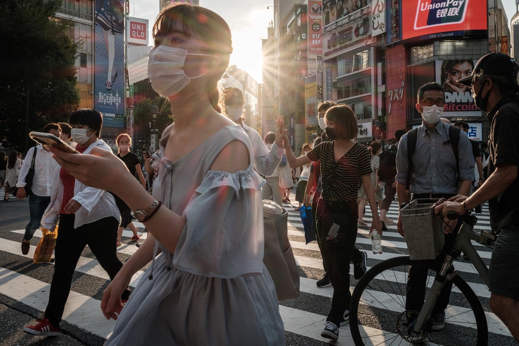 People wear face masks in Tokyo on July 28. Photo: AFP