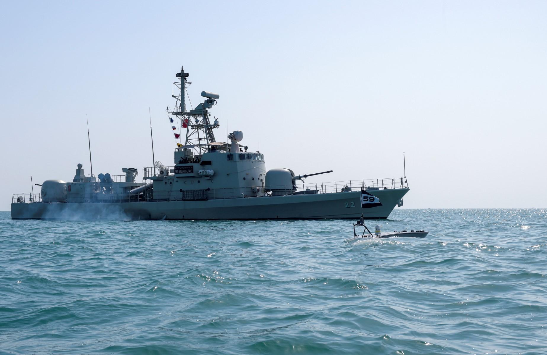A Man-Portable Tactical Autonomous Systems T-12 unmanned surface vessel sails alongside Royal Bahrain Naval Force Abdulrahman Al Fadhel in the Gulf waters during a joint naval exercise between US 5th Fleet Command and Bahraini forces, on Oct 26. Photo: AFP