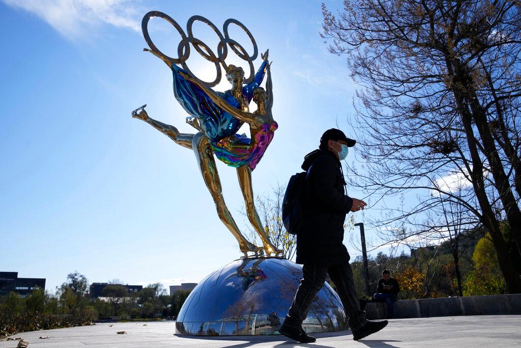 A visitor to the Shougang Park walks past a sculpture for the Beijing Winter Olympics in Beijing, China, Nov 9. Photo: AP