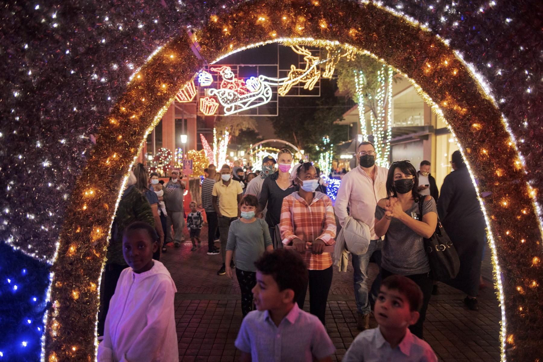 People enjoy Christmas decorations in Melrose Arch, Johannesburg, on Dec 21. Photo: AFP