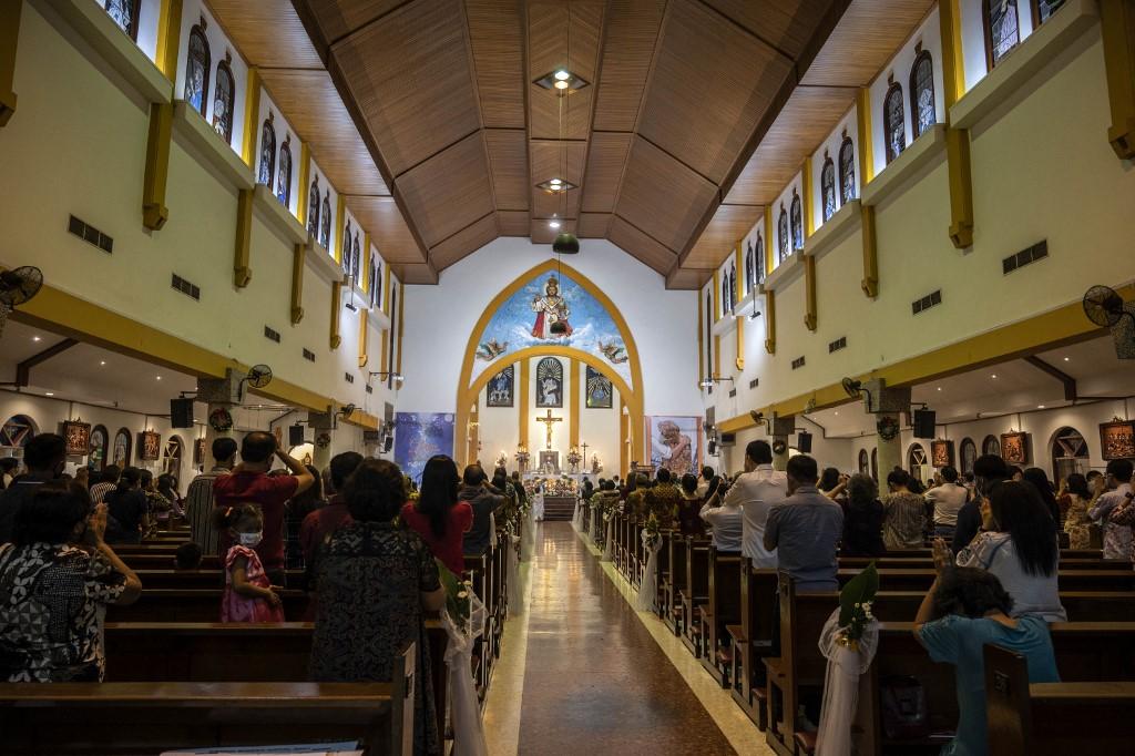Christians attend Christmas Eve mass at a church in Surabaya on Dec 24. Photo: AFP