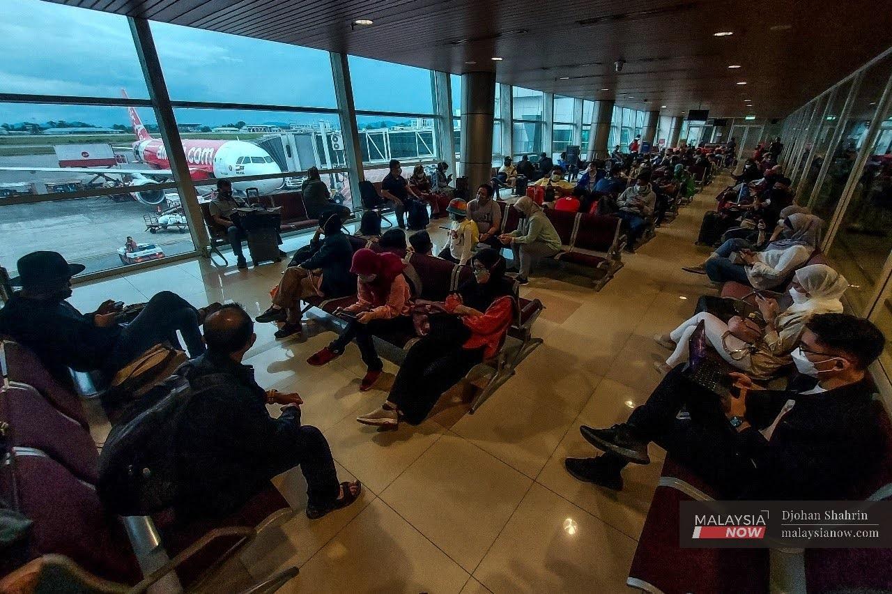 Travellers await a flight from Kuching to Kuala Lumpur at the Kuching International Airport in Sarawak.