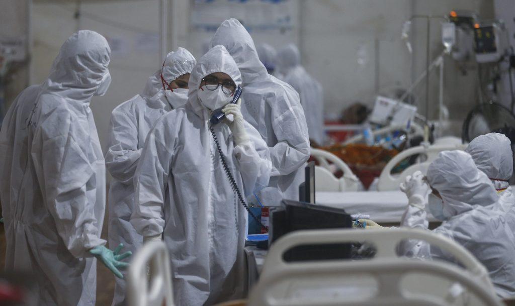 A doctor speaks on the intercom with a senior consultant giving an update of a patient at the BKC jumbo field hospital, one of the largest Covid-19 facilities in Mumbai, India, May 6. Photo: AP