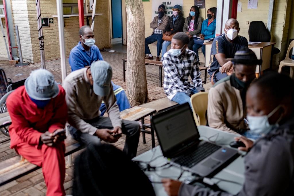 People queue at a clinic to receive a vaccine shot against Covid-19 in Johannesburg on Dec 8. Photo: AFP