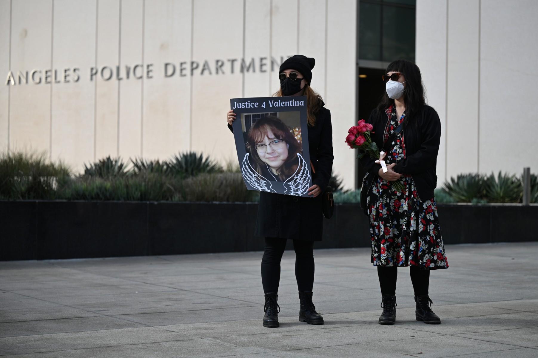 A protester holds a photo calling for justice for 14-year old Valentina Orellana-Peralta, who was killed by a stray police bullet last week while shopping at a clothing store, during a press conference outside Los Angeles Police Department headquarters in Los Angeles, California, Dec 28. Photo: AFP
