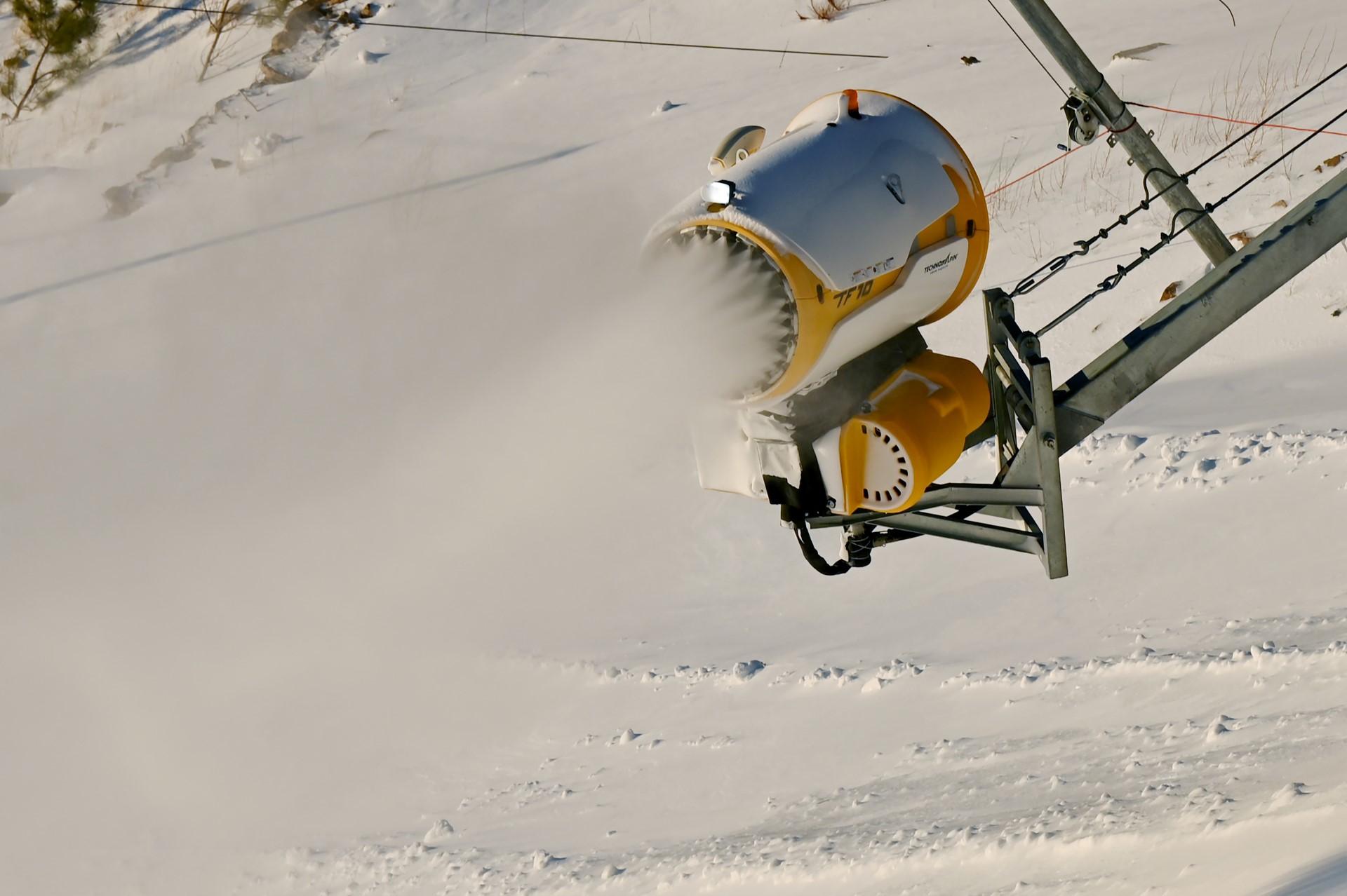 This file photo taken on Dec 17, shows a snow machine spreading artificial snow at the National Alpine Skiing Centre, venue for the Beijing 2022 Winter Olympic Games, in Yanqing. Photo: AFP