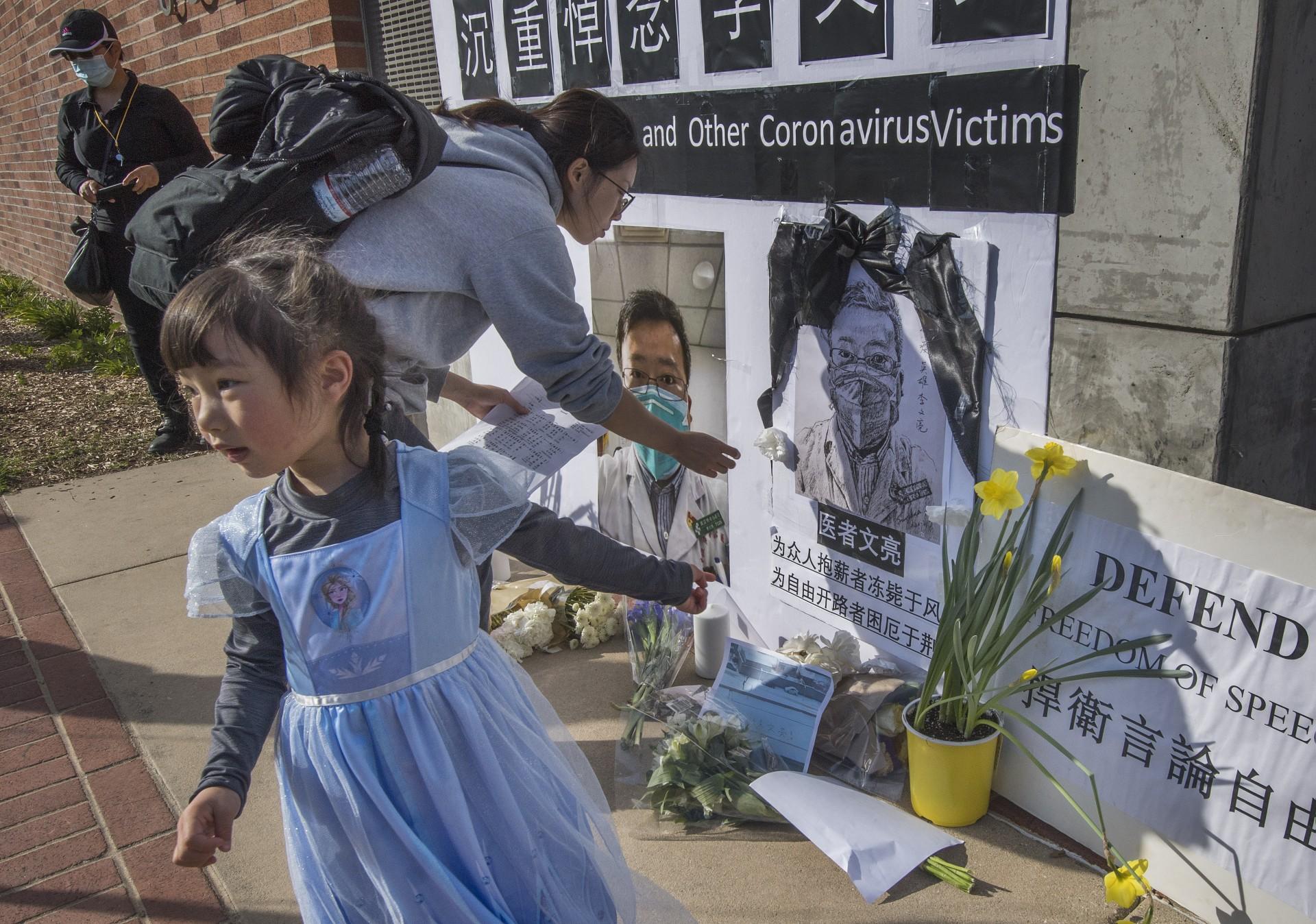 Chinese students and their supporters hold a memorial for Dr Li Wenliang, who was the whistleblower of Covid-19, that originated in Wuhan, China and caused the doctor's death in that city, outside the UCLA campus in Westwood, California, on Feb 15, 2020. Photo: AFP