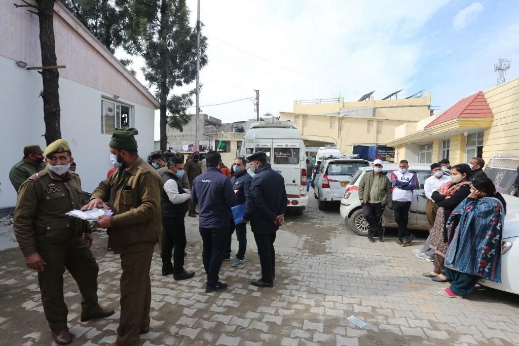 Officials and relatives gather outside a mortuary after the bodies of victims of a stampede at the Vaishno Devi shrine, one of the country's most revered Hindu sites, were brought to Katra on Jan 1. Photo: AFP
