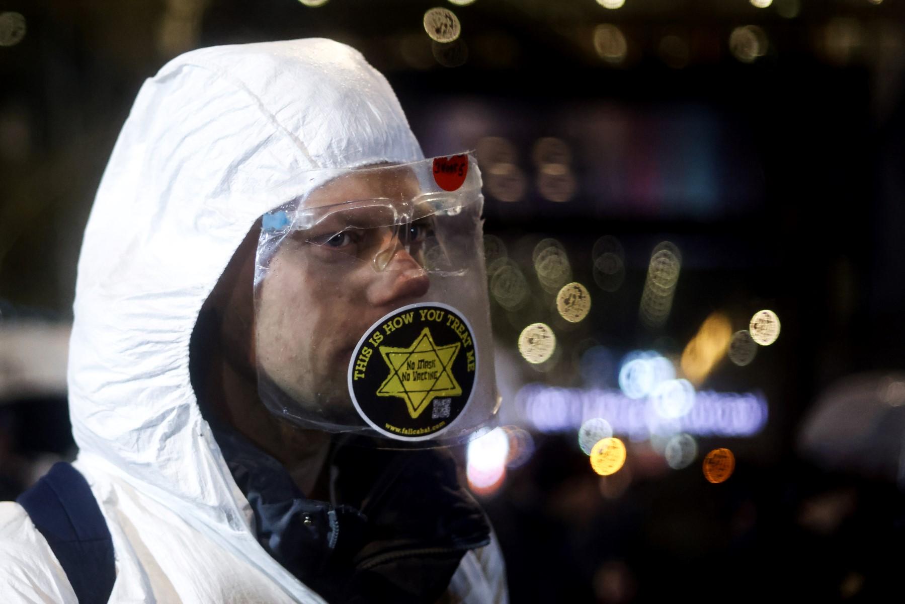 A demonstrator with a star of David takes part in a protest against new restrictions to curb the spread of Covid-19 outside the Ministry of Justice and Security in The Hague on Nov 26, 2021 amid the Covid-19 pandemic. Photo: AFP