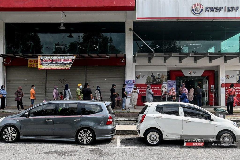 People line up in front of an EPF branch in Bandar Baru Nilai, Negeri Sembilan, following the government's announcement last year that contributors would be allowed to withdraw funds from their Account 1.