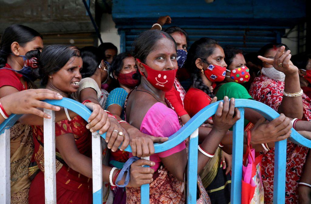 Women wait to receive a dose of Covid-19 vaccine outside a vaccination centre in Kolkata, India, Aug 31, 2021. New cases passed 100,000 on Friday and authorities in several megacities have brought in restrictions as they seek to slow the spread of the virus. Photo: Reuters
