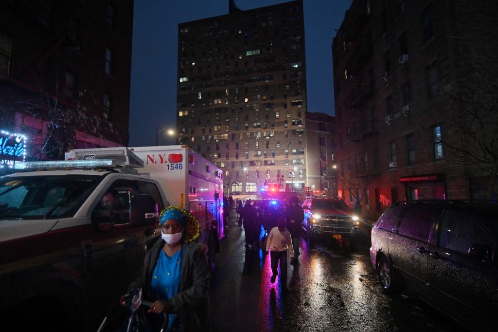 Residents are pictured near the scene of the fatal fire of an apartment building in the Bronx, on Jan 9, in New York. At least 19 people have died and dozens are injured after a fire tore through a high-rise apartment building in the New York borough of the Bronx. Photo: AFP