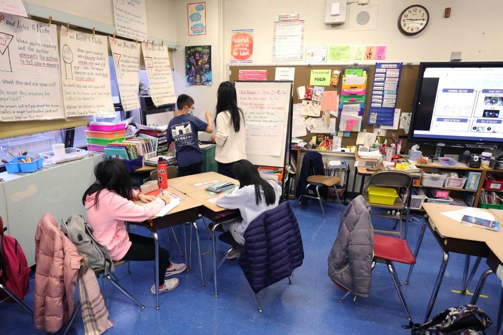 A teacher at Yung Wing School PS 124, gives students a lesson in her classroom on Jan 5 in New York City. Photo: AFP