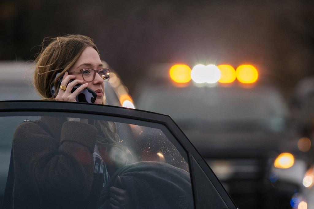 A woman speaks on the phone near the Congregation Beth Israel synagogue on Jan 15 in Colleyville, Texas. Photo: AFP