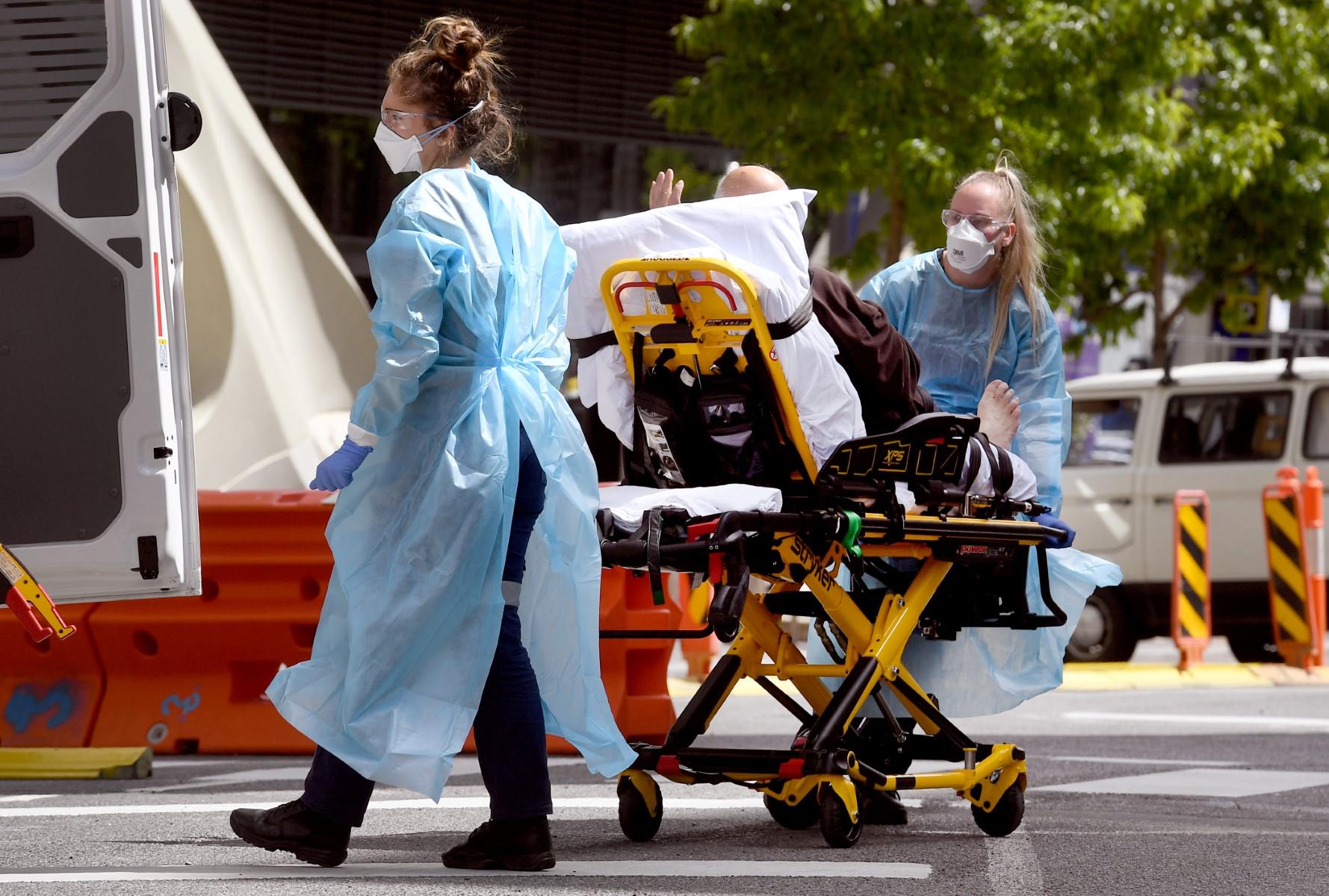 Medical staff transport a patient from the Royal Melbourne Hospital in Melbourne on Oct 9, 2021. Photo: AFP