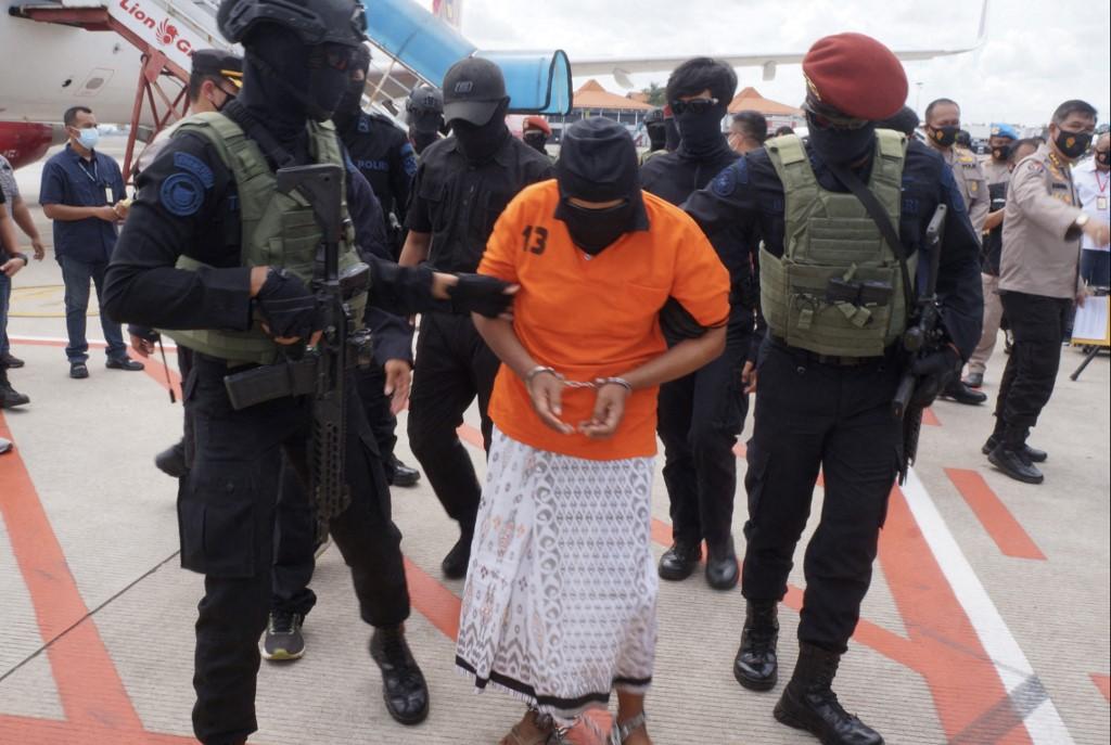 This file photo taken on Dec 16, 2020 shows police escorting Zulkarnaen, a senior leader of the Al-Qaeda-linked Jemaah Islamiyah, who had been on the run for his alleged role in the 2002 Bali bombings, upon arrival at Jakarta’s Soekarno-Hatta International Airport in Tangerang. Photo: AFP