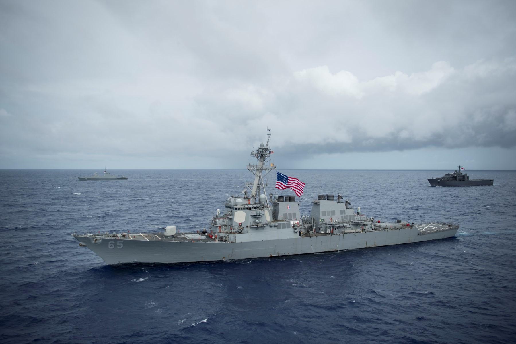 This image released by the US Navy, shows the Arleigh Burke-class guided-missile destroyer USS Benfold (front) Republic of Singapore Navy’s RSS Supreme, and RSS Endurance, during Exercise Pacific Griffin 2017, off the coast of Guam, Aug 28, 2017. Photo: AFP