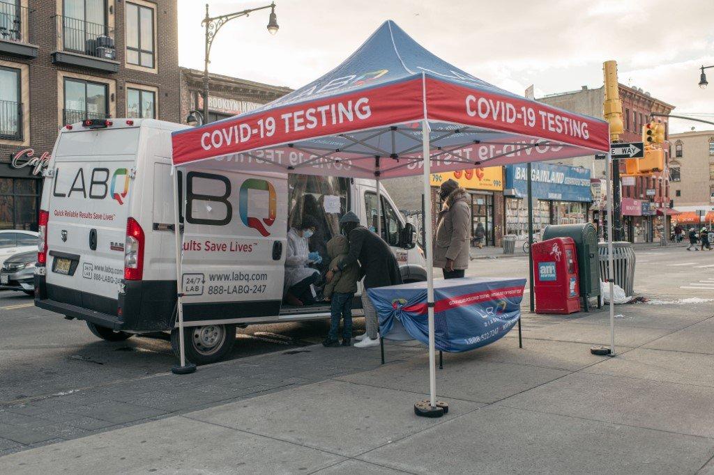 New York residents walk up to a mobile Covid-19 testing van in the Bed-Stuy neighborhood of Brooklyn on Jan 10, in New York City. Photo: AFP