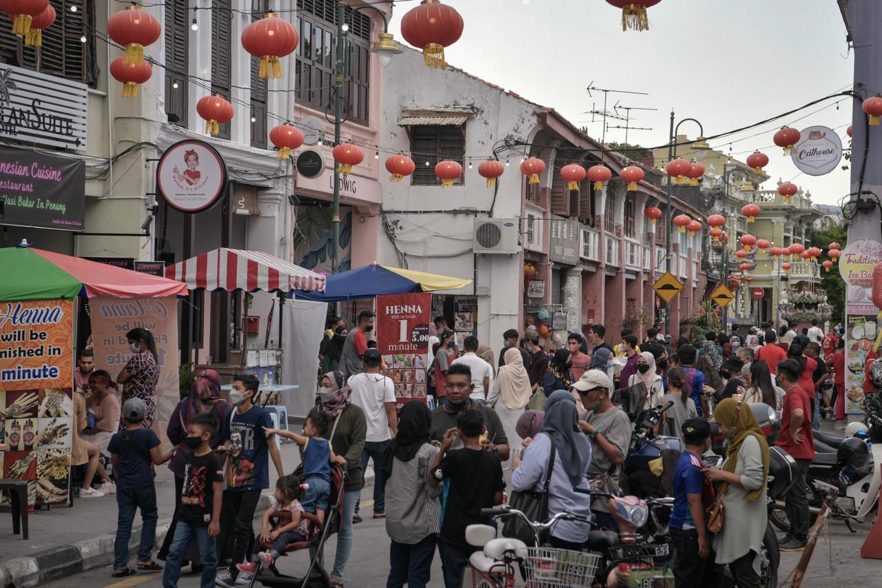 Tourists and locals mingle at Armenian Street in George Town during the Chinese New Year holidays. Photo: Bernama