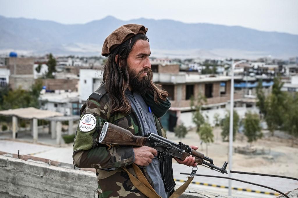 A Taliban fighter mans a post on the rooftop of the main gate of Laghman University in Mihtarlam, Laghman province on Feb 2. Photo: AFP