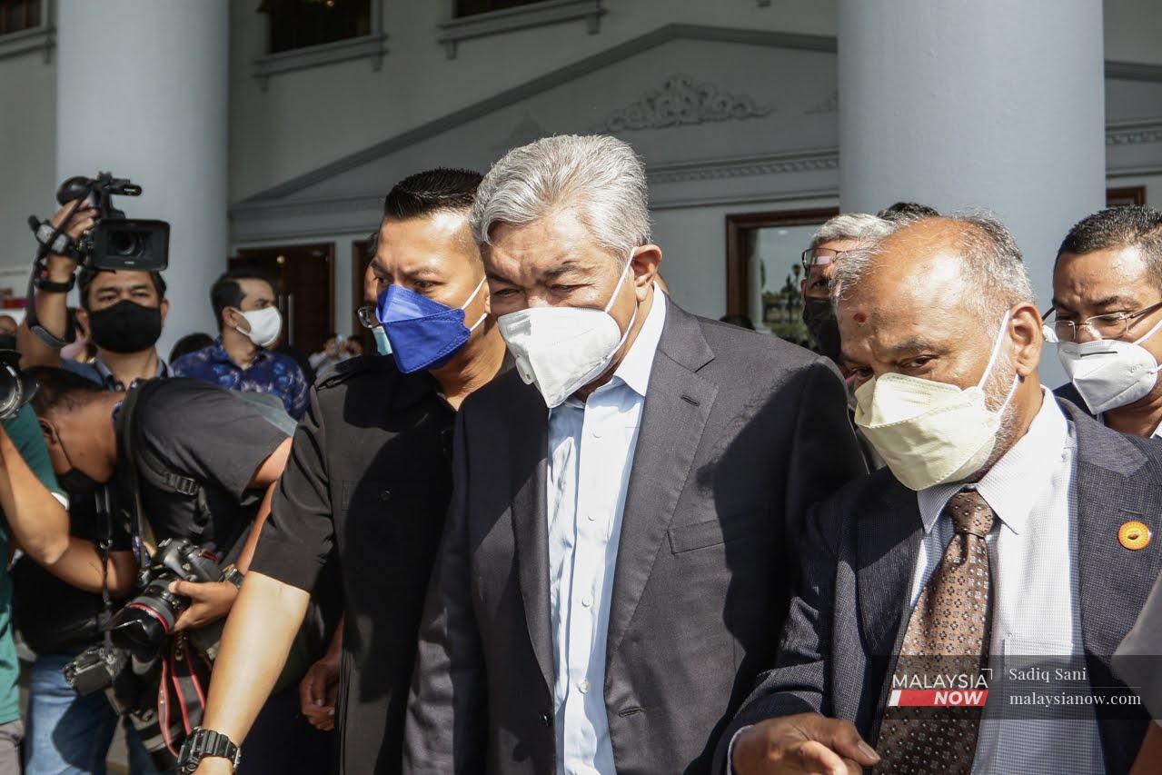 Umno president Ahmad Zahid Hamidi leaves the Kuala Lumpur court complex on Jan 24 after being told to enter his defence for 47 corruption charges related to millions in charity funds.