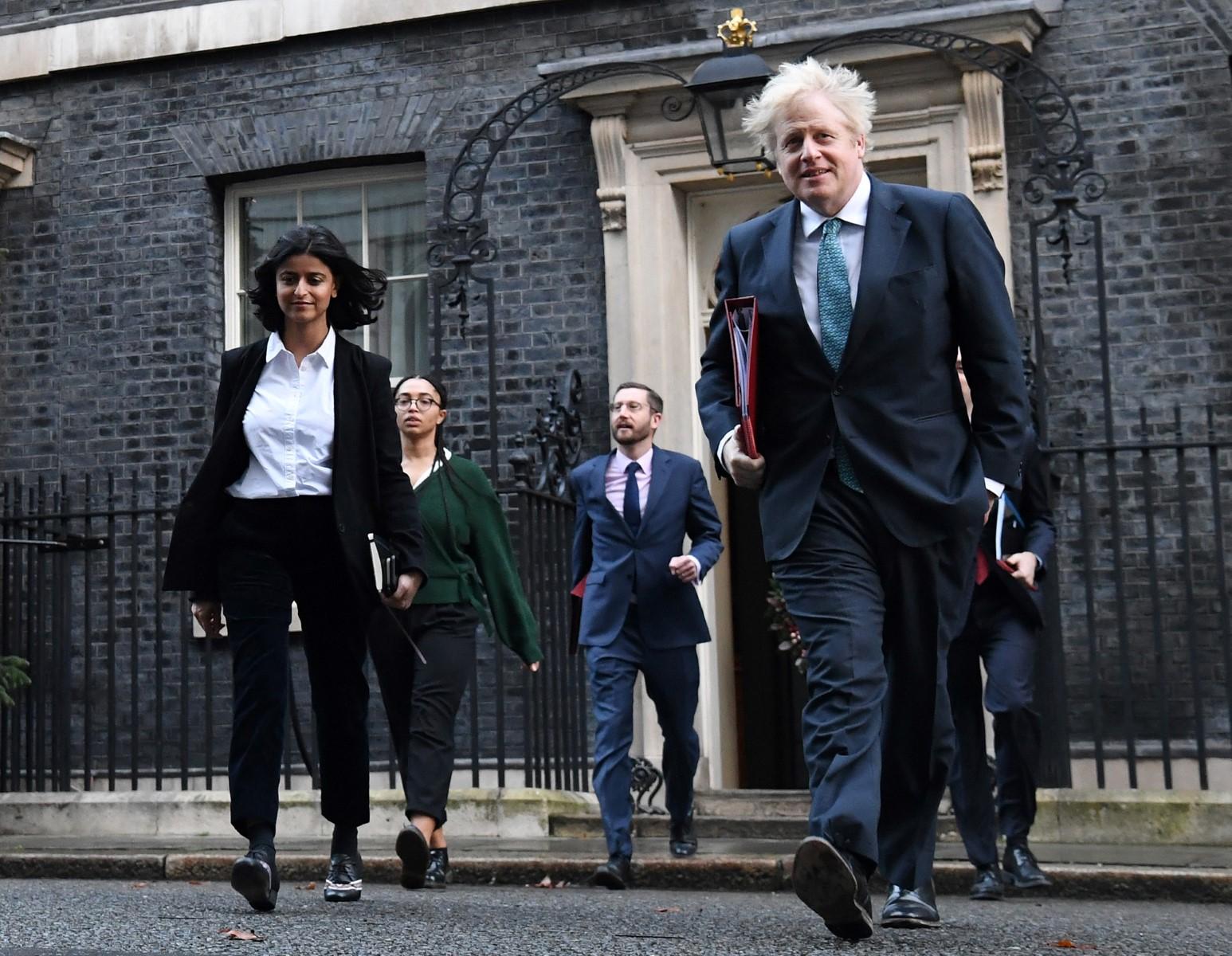 In this file photo taken on Dec 15, 2020 Britain's Prime Minister Boris Johnson (right) leaves 10 Downing Street in London with director of the Number 10 Policy Unit Munira Mirza (left) to attend the weekly cabinet meeting held at the nearby Foreign, Commonwealth and Development Office. Photo: AFP