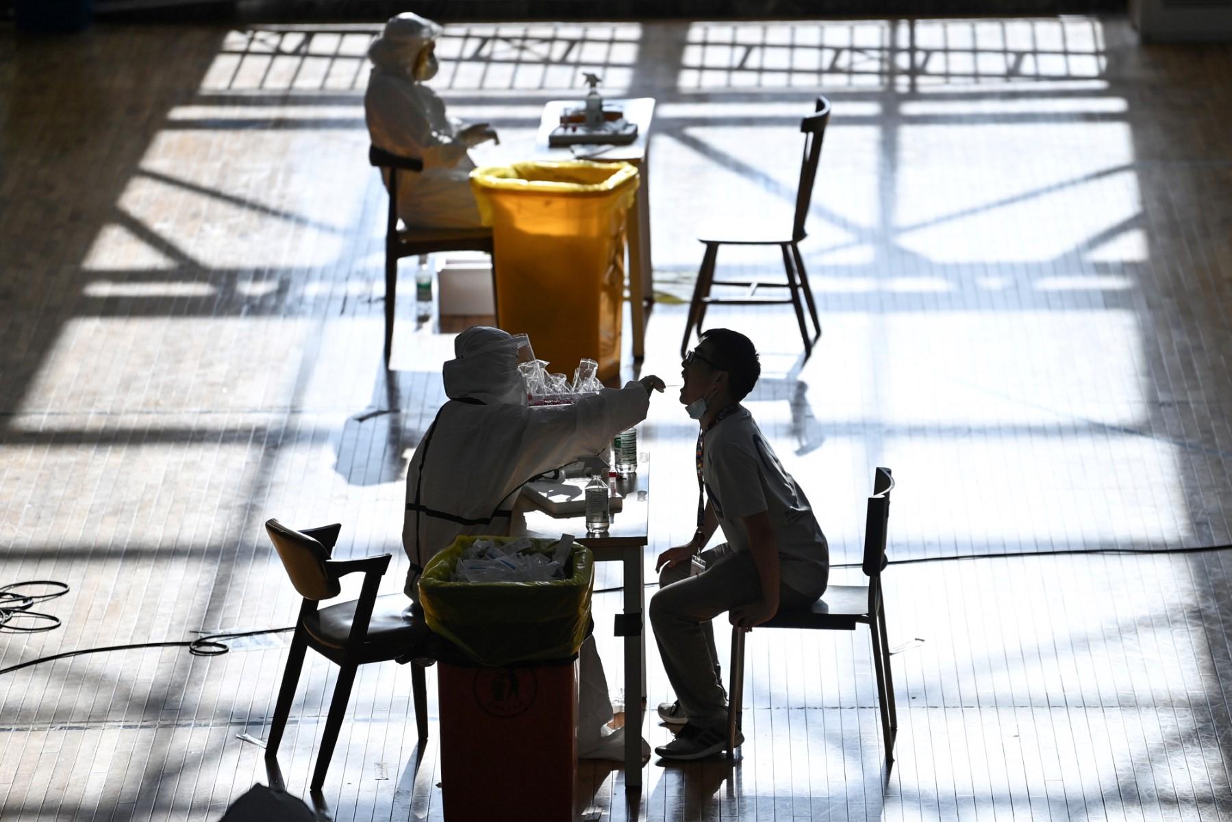 This photo taken on Aug 5, 2021 shows a staff member being given a nucleic acid test for Covid-19 at the gym of a company in Wuhan in China's central Hubei province. Photo: AFP