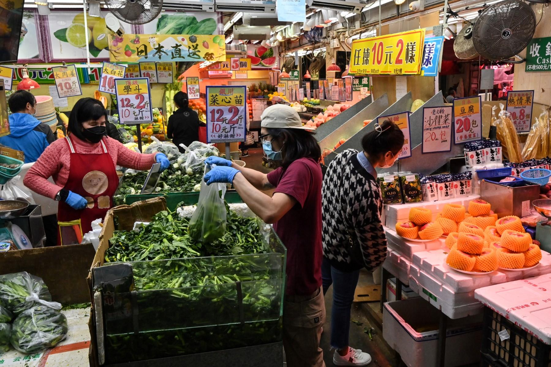 People shop for fruit and vegetables at a market in Hong Kong on Jan 13. Photo: AFP